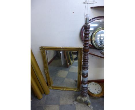 A gilt framed mirror and standard lamp