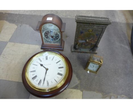 A brass carriage clock, a Shaw of London wall clock and two others