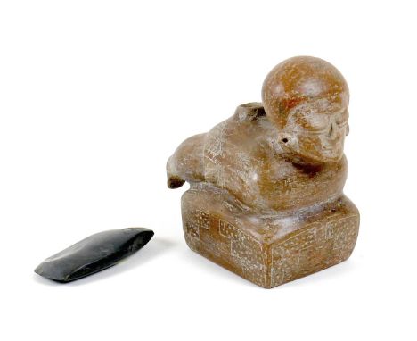 A Pre Columbian pottery vessel, modelled as a figure lying on it's front with head raised, on an integral rectangular base, w