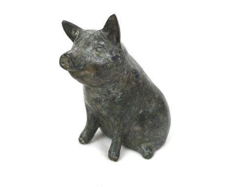 A Chinese bronze sculpture, modelled as a sitting pig, 8cm high. 