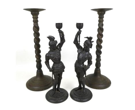 Two pairs of decorative candlesticks, comprising a pair of Art Nouveau spelter figural candlesticks, in the form of medieval 