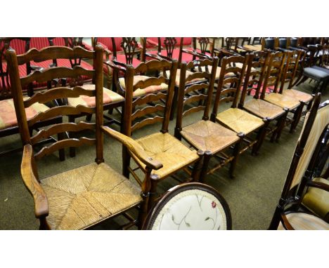 Seven rush seated ladder back chairs 