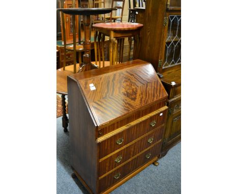 A 19th century mahogany tilt top tripod table, a reproduction bureau, similar plant stand and nest of tables