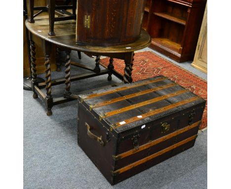 A 1920's oak gate leg dining table together with a wooden and metal bound travelling trunk