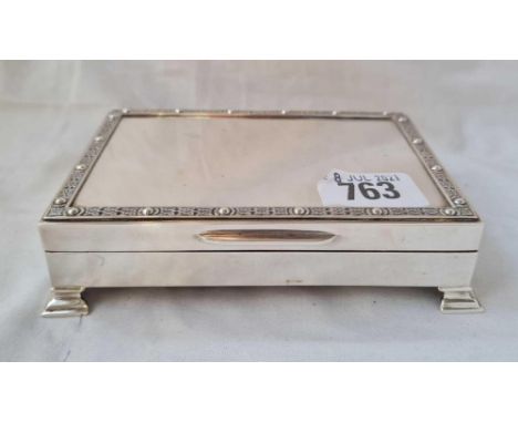 A good quality cigarette box with Celtic style border on bracket feet - 5" wide - Birmingham 1964 