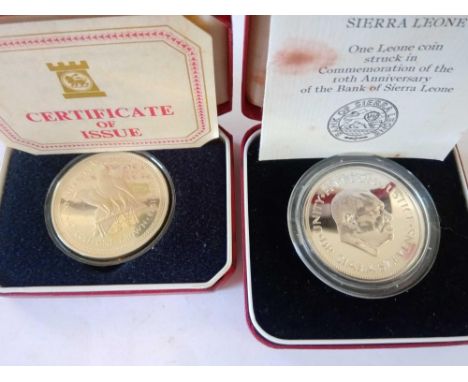 Silver I-O-M proof crown 1978 with paperwork and Bank of Sierra Leone silver coin.  Both boxed