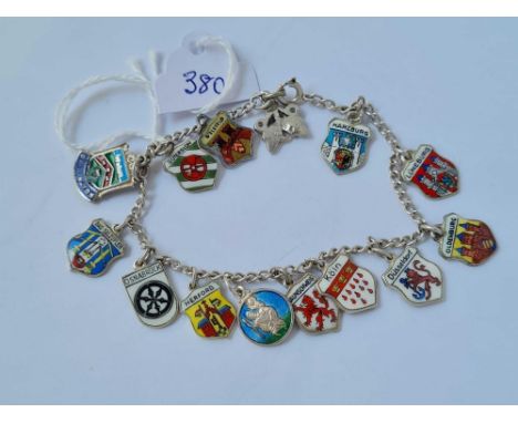 A silver charm bracelet mainly with silver and enamel flag charms - 18.7 gms 
