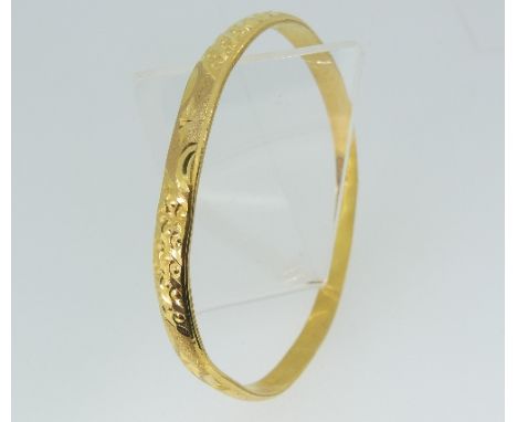 A 22ct yellow gold Slave Bangle, with foliate and star decoration, marked 'Bufeena 22c' on the interior, approx total weight 