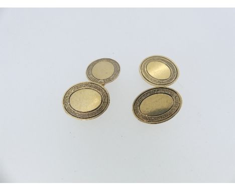 A pair of 9ct yellow gold oval Cufflinks, the fronts and reverses with engine turned border decoration, chain between, approx