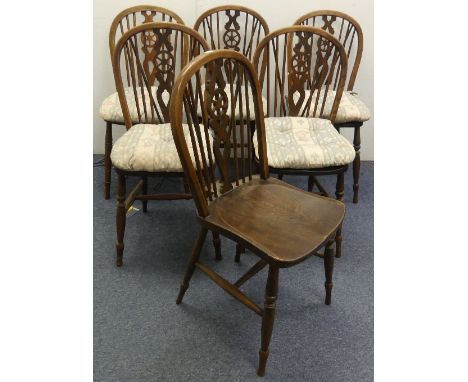 A set of six early 20thC ash and elm Wheelback Dining Chairs, the hooped back enclosing stick supports and central pierced ba