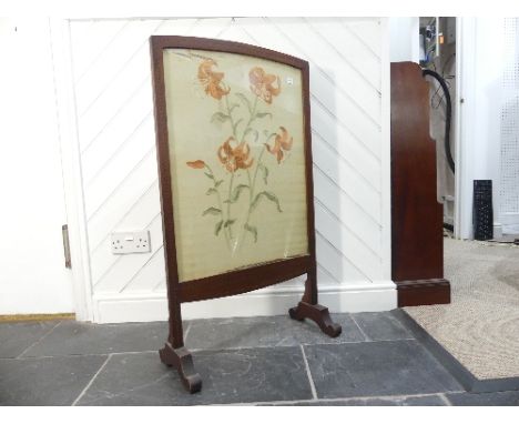 An Edwardian mahogany and inlaid Footstool, the stuffed seat as hinged lid, upon turned legs, caps and castors, 19½in (50cm) 