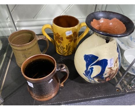A small quantity of Studio Pottery; comprising two Leach Pottery Tankards, one decorated with brown glaze, the other in green