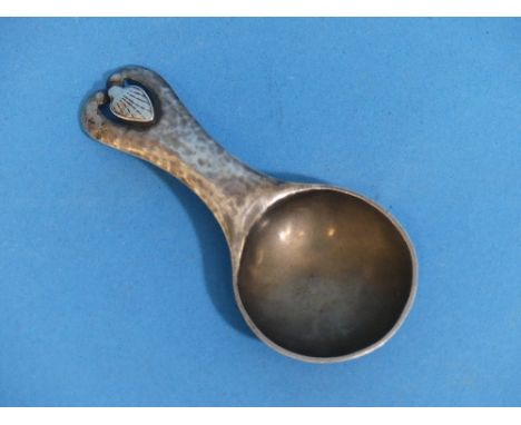 An Arts &amp; Crafts 'Newlyn' silver Caddy Spoon, hallmarked London, 1910 and Newlyn, makers mark R.T.D, probably Reginald Th