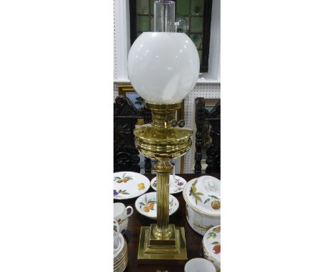 An Edwardian brass Oil Lamp, of classical column form on stepped square base, with white glass shade and plain funnel, overal