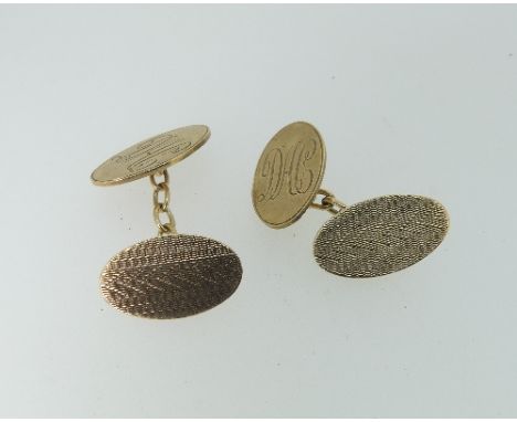 A pair of 9ct yellow gold oval Cufflinks, with chain between, one side engine turned, the other with initials, total weight 6