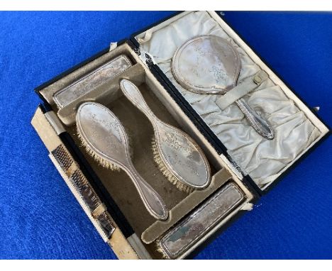 A cased six piece George V silver backed Dressing Table Set, hallmarked Chester, 1924, comprising two hair brushes, two cloth