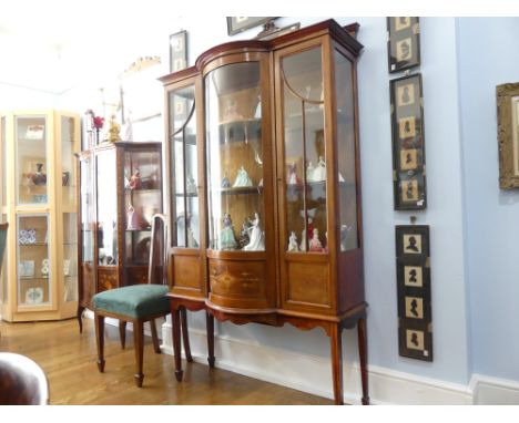 An Edwardian mahogany and inlaid Display Cabinet, the moulded pediment above central bowed glazed panel, and doors either sid