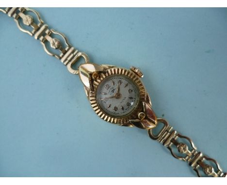 A lady's Rotary gold plated Wristwatch, on a 9ct gold open link bracelet, gross total weight 12g.