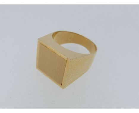 An 18ct yellow gold gentleman's Signet Ring, the square front with vacant centre, engine tuned shoulders, Continental mark on