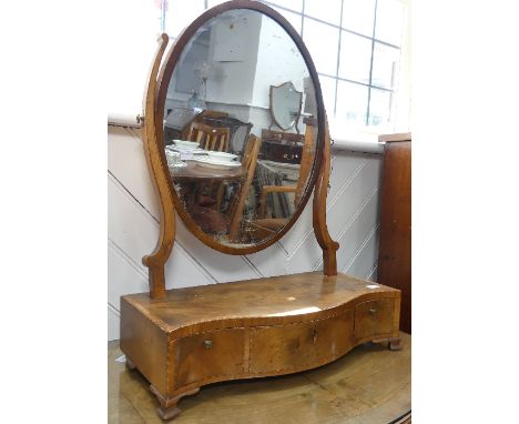 A Victorian walnut and inlaid Toilet Mirror, the cross banded and inlaid frame with oval plate, raised on serpentine shaped b