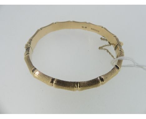 A 9ct yellow gold textured hollow Hinged Bangle, approx total weight 13.6g.