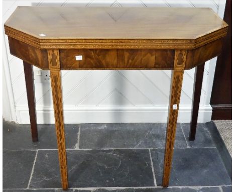 A George III mahogany and inlaid Card Table, the cross-banded top with fold over action and octagonal shape, strung with geom