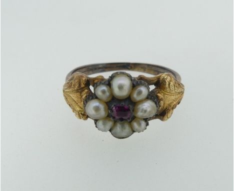 An antique ruby and seed pearl cluster Ring, the eight seed pearls surrounding ruby centre with engraved shoulders, in unmark