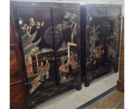 A pair of early 20thC Chinese Lacquer Cabinets, the two with raised decoration of flora and fauna, with the twin doors decora