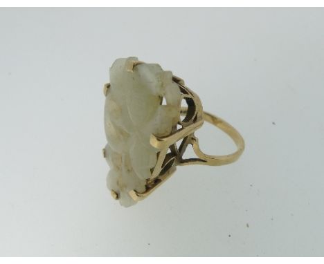 A carved and pierced pale Jade Ring, foliate design, in a 9ct rose gold mount, hallmarked 1972, Size N, the jade approx 3cm l