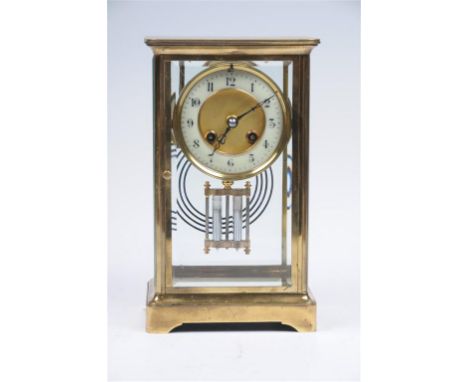 A late 19th century french brass cased four glass manTEL clock with a 9cm white dial with arabic numerals, the two train spri