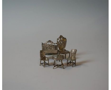 A collection of assorted continental silver miniature dolls house furniture, to include two seater sofa, three assorted chair