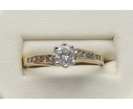 A contemporary 9ct gold diamond single stone ring, the central round brilliant cut diamond estimated 0.35cts, claw set to rou