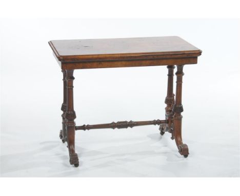 A Victorian bur walnut games table the rectangular hinged top with a moulded border with a red beige and gilt Morocco border 