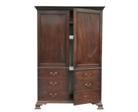 A 19th century mahogany gentleman's wardrobe with an ovolo cornice above a dentil frieze and a pair of cupboard doors, panell
