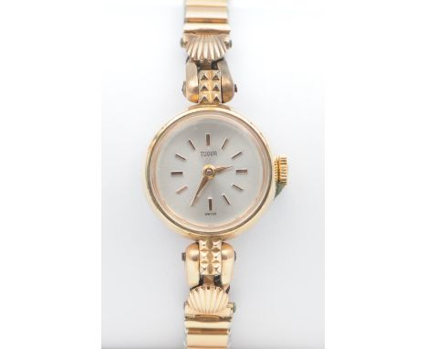 A ladies gold plated Tudor manual wind bracelet watch, the champagne dial with applied batons signed Tudor, the circular gold