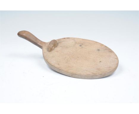 A Robert Mouseman Thompson shaped oval oak   bread plate carved with a mouse, 37cms