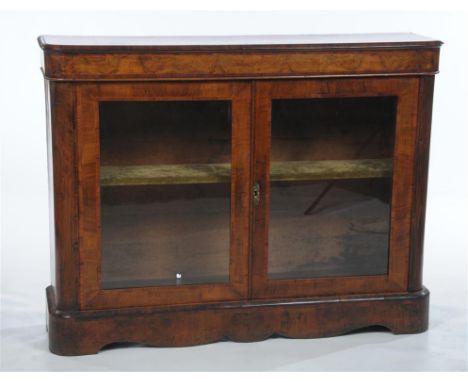 A Victorian bur walnut and inlaid cabinet, the shaped rectangular top with rounded corners above a frieze inlaid with Rosewoo