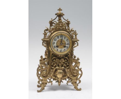 A French brass mantel clock with a 9cm white enamel dial with Arabic numerals the two train movement with outside countwheel 