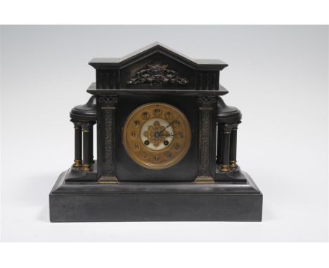 A Victorian black slate architectural mantel clock with 12cm dial with Arabic numerals, foliate pierced centre the two train 