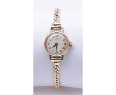 A Vintage ladies 9ct gold Tudor Royal manual wind wristwatch, the cream Arabic dial to circular 9ct gold case and 9ct gold cu