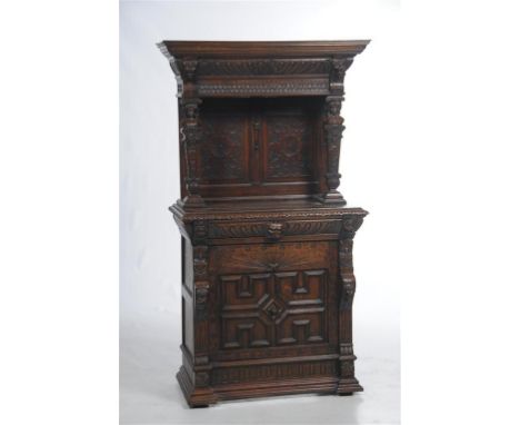 A Victorian carved oak sideboard in the Jacobean style with a cavetto cornice above a leaf gadroon and scale frieze above a p