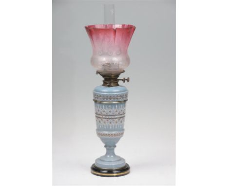 A Victorian opaque glass paraffin lamp with a ruby and clear glass acid etched tulip shape shade, clear glass funnel, opaque 