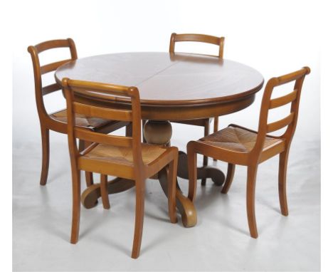 A Roger Chevron Grange extending elm dining table with two D shape ends crossbanded border, with two leaves and four conformi