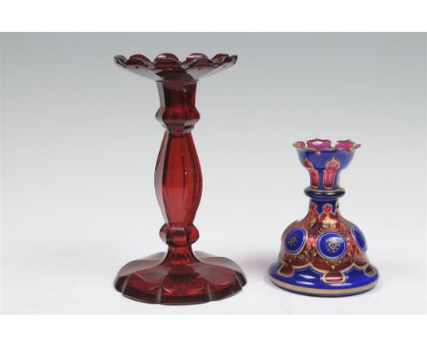 A late 19th century ruby and blue overlaid glass candle holder with a leaf shape rim, minor chip above ruby and gilt panels o