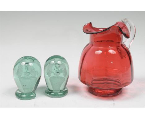 A Victorian ruby tinted and clear glass jug with a trefoil shaped spout, ribbed conical body raised upon a circular base 16.5