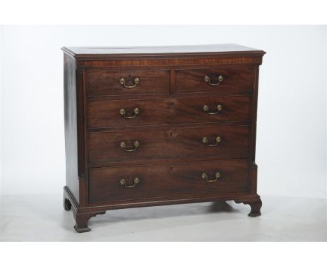 A George III mahogany and crossbanded chest of drawers, the rectangular moulded top above an inlaid frieze, two short and thr
