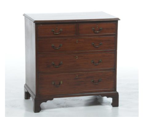 An early 19th century mahogany chest of drawers, the rectangular crossbanded top with a moulded border above two short and th