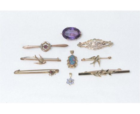 A collection of seven early 20th Century and later brooches to include an oval mixed cut amethyst within a stamped 9ct brooch