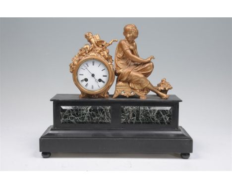 A Victorian gilt spelter and black slate figural mantel clock with an 8.5cm white enamel dial with Roman numerals, the two tr