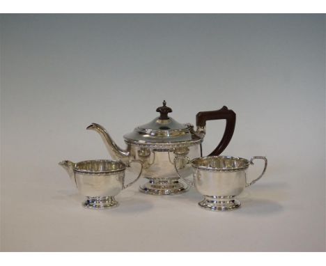 An Edward VII hallmarked silver three piece tea service, each having a cast floral rim, made by Lanson Ltd Birmingham 1909, t